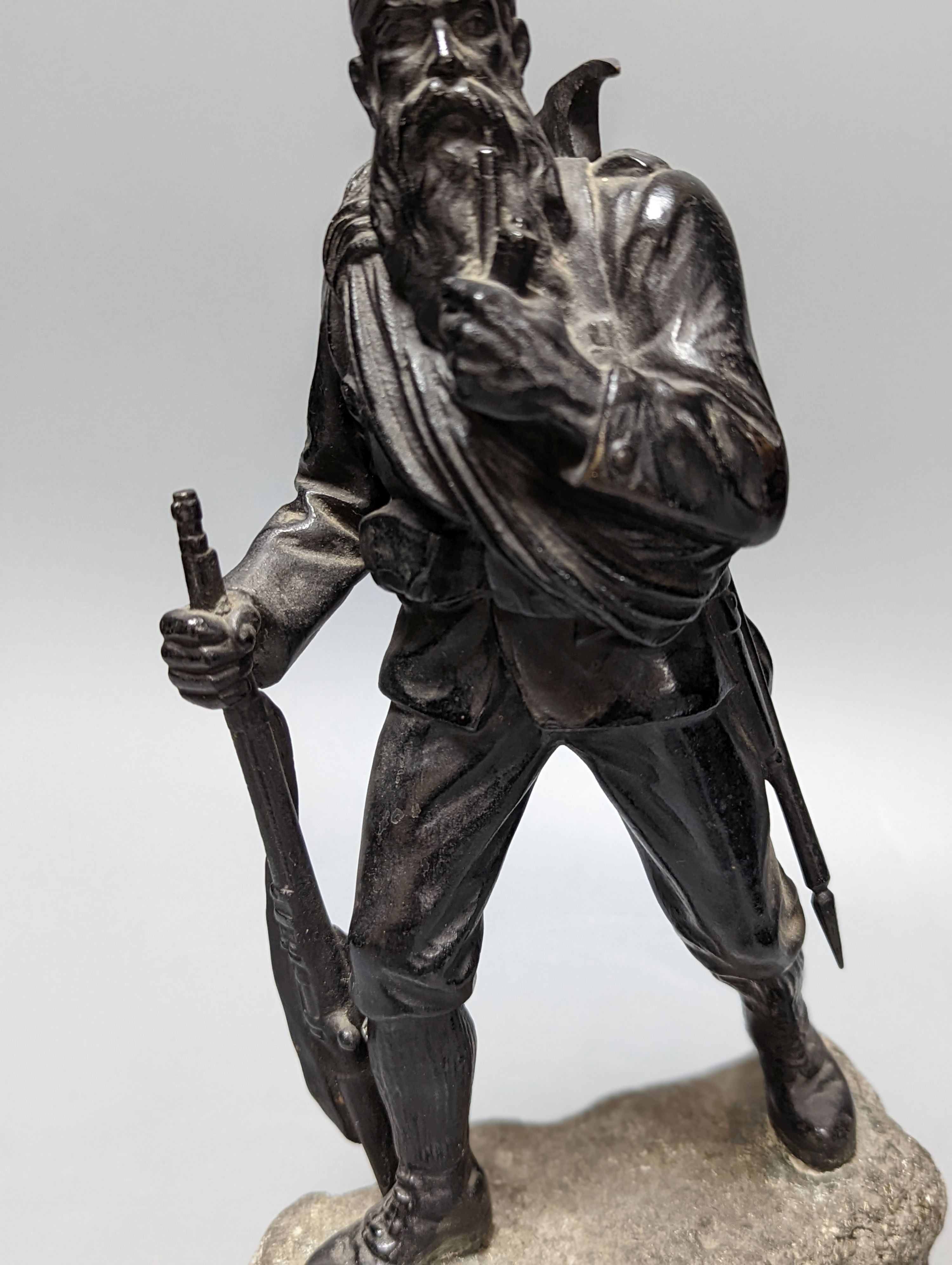 A WW1 period bronze figure of an Austrian soldier, 30 cms high including stone base.